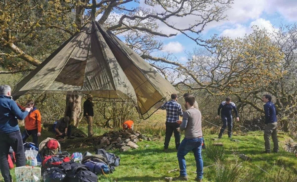 Group of men setting up a tent for their stag do activity in Cardiff