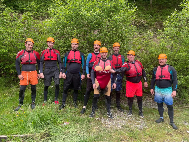 Group of men posing for a photo before starting their gorge walking adventure in wales