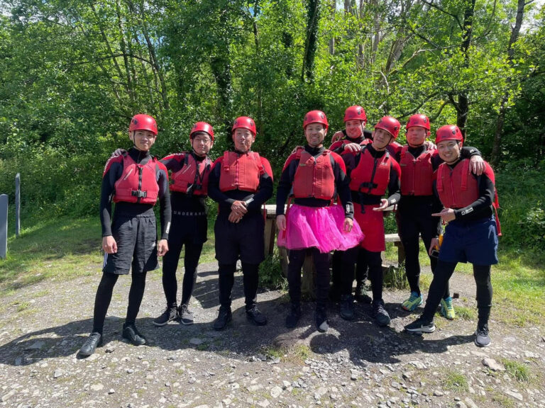 Group of men with safety vests and gears ready for their gorge walking stag do activity in Cardiff