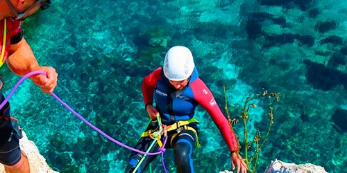 A person doing water abseiling in Majorca